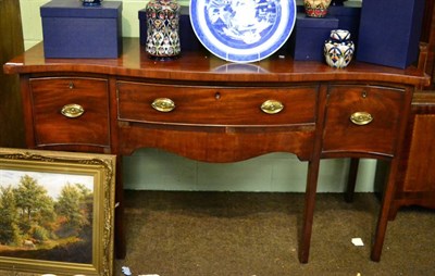 Lot 1423 - A George III mahogany serpentine sideboard