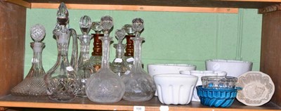 Lot 108 - Seven ceramic and glass jelly moulds and nine various cut glass and other decanters with stoppers