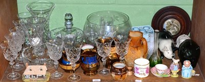 Lot 111 - Shelf including two pot lids in circular oak frames, three pottery piggy banks, 19th century...