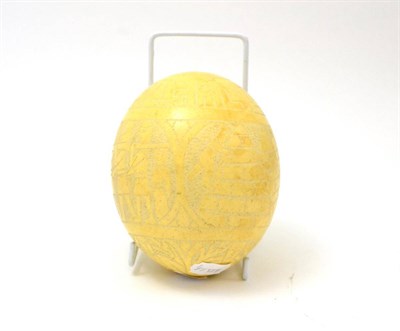 Lot 131 - An ostrich egg carved with Egyptian scenes