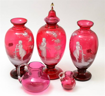 Lot 151 - A Mary Gregory cranberry glass garniture of vases, a similar small jug and a cranberry jug