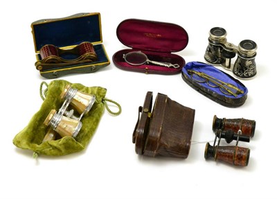 Lot 156 - A pair of tan leather opera glasses with compass to front in similar leather case, similar...