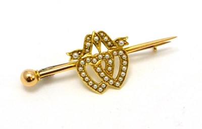 Lot 275 - A seed pearl set entwined heart brooch, stamped '15CT'