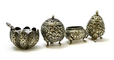 Lot 281 - A 19th century Burmese silver cruet set; consisting of two pepperettes and two salts, together with