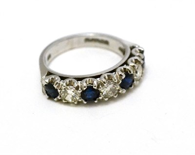 Lot 286 - An 18ct white gold sapphire and diamond half hoop ring