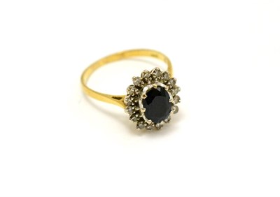 Lot 297 - An 18ct gold sapphire and diamond cluster ring (approx 1ct sapphire)