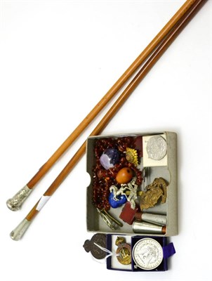 Lot 391 - An amber necklace, military badges, two swagger sticks etc