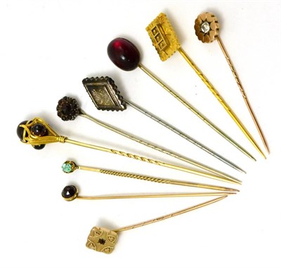 Lot 403 - A group of sixteen stick pins, some cased, including garnet set examples and some buttons