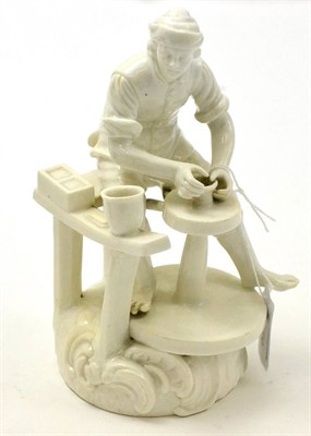 Lot 418 - A Derby porcelain figure of a potter, underglaze blue marks to base