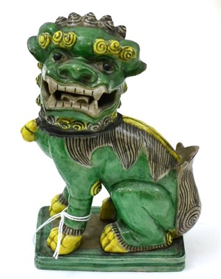 Lot 427 - A 19th century Chinese porcelain temple lion, enamelled in green and yellow