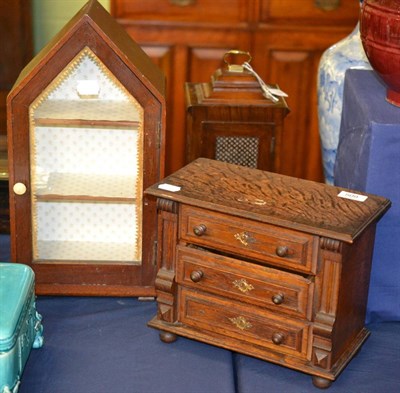 Lot 509 - A miniature oak chest of drawers and a glazed cabinet with pitched top (2)