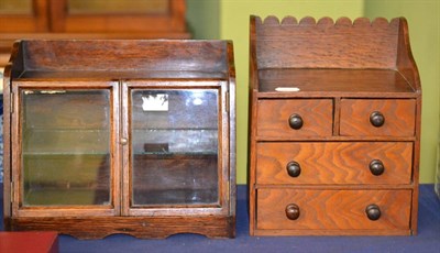 Lot 511 - A doll's early 20th century oak chest of drawers and small glazed cabinet