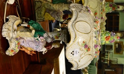 Lot 547 - A Continental flower encrusted figural lamp and shade