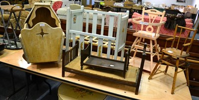 Lot 1023 - Doll's painted drop-side cot, two oak bedsteads, pink high chair, dolls chair, a painted table...