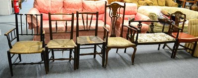 Lot 1041 - An Edwardian inlaid mahogany sofa, an Edwardian inlaid mahogany elbow chair and three rush...