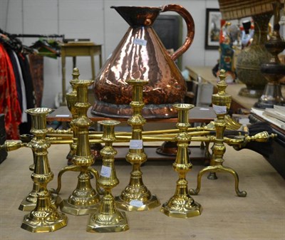 Lot 1070 - A copper warming stand and jug, six pairs of candlesticks, fire dogs and irons etc