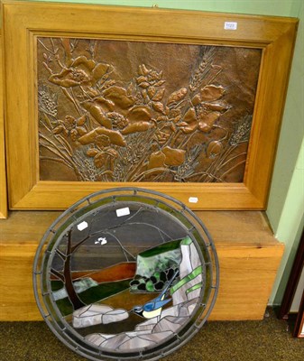 Lot 1123 - Decorative embossed copper panel in a wooden frame, together with a circular stained glass panel