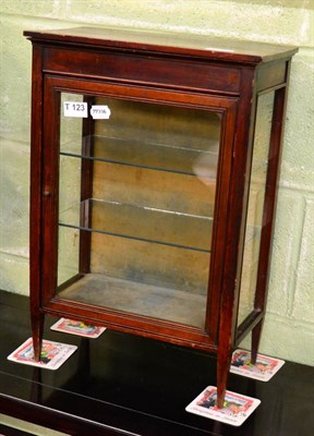 Lot 1171 - A small mahogany table top display cabinet on four legs, single glazed door