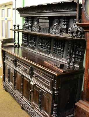 Lot 1181 - A large carved oak sideboard