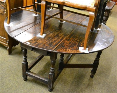 Lot 1203 - A large oak gateleg table