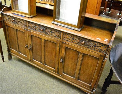 Lot 1205 - A 1920's carved oak sideboard