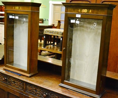 Lot 1206 - Two similar walnut wall mounting display cabinets with glazed doors