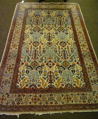 Lot 1216 - An unusual Kashan rug, Central Persia, the cream field of angular plants enclosed by borders of...