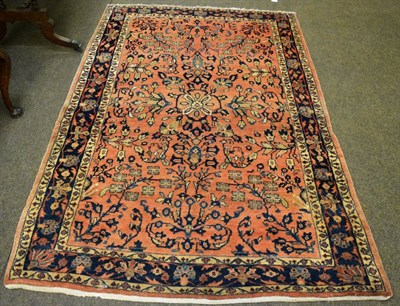 Lot 1217 - Saroukh rug, West Persia, the rust ground with flowering boughs enclosed by indigo borders of...