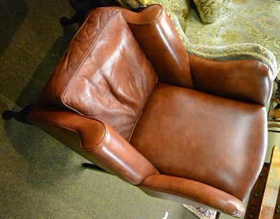 Lot 1221 - Modern brown leather upholstered wing armchair