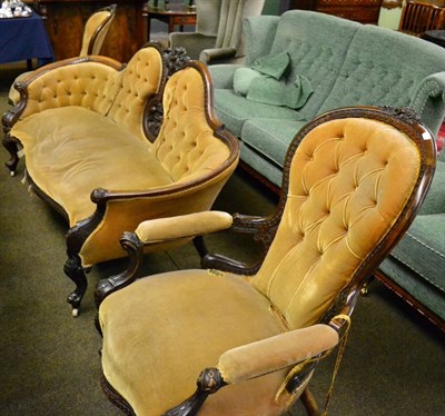 Lot 1243 - Victorian walnut framed three piece suite upholstered in yellow velvet comprising settee,...