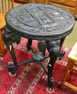 Lot 1247 - Late 19th/early 20th century ebonised and carved circular centre table, the legs carved as elephant