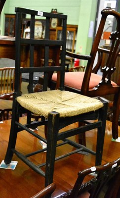 Lot 1256 - An ebonised cafe chair, the shaped top rail, above an extending lattice back to lower...