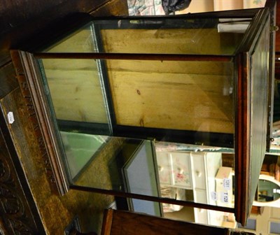 Lot 1261 - J S Fry & Sons display cabinet with glass front and sides, mirrored internal base, two height...