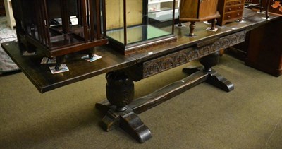 Lot 1265 - Carved oak draw leaf refectory style table on stretcher base