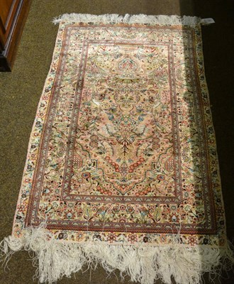 Lot 1301 - A Chinese silk prayer rug, the candy pink field centred by an urn issuing flowers beneath the...