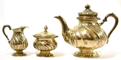 Lot 5 - A German three piece silver tea set, of wrythem form, stamped 800 with crown (3)