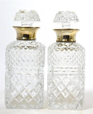 Lot 8 - A pair of cut glass decanters with silver collars