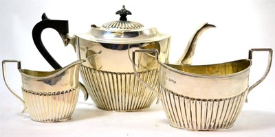Lot 23 - An Edwardian silver three piece tea set, Chester 1906 (3)