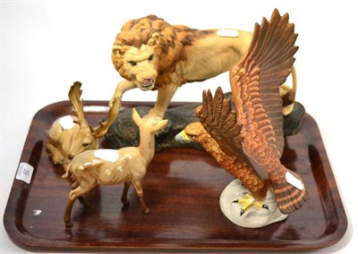 Lot 39 - A group of four Beswick models including golden eagle, lion, fawn and deer