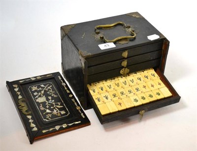 Lot 43 - A late 19th mother-of-pearl inlaid Mahjong cabinet and bone pieces