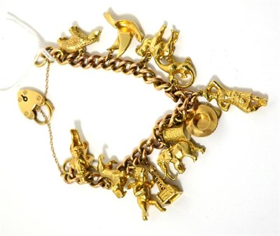 Lot 62 - A gilt metal charm bracelet, with attached 9ct gold Blackpool tower charm and clasp stamped '9CT'