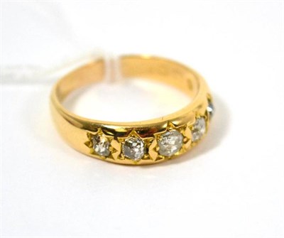 Lot 69 - A five stone diamond gypsy set band ring