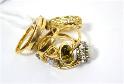 Lot 94 - A diamond ring, a band ring, a patterned band ring stamped '585' and four stone set dress rings (7)