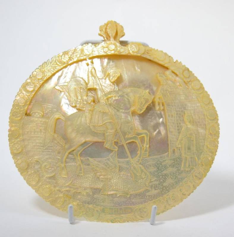 Lot 114 - A carved mother of pearl shell depicting a figure on horseback and inscribed beneath ";Bethlehem"