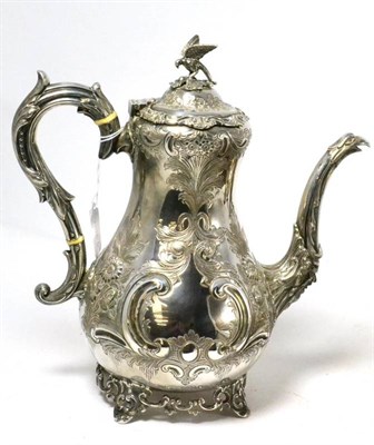 Lot 173 - A silver coffee pot with embossed decoration and an eagle finial
