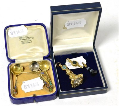 Lot 201 - A set of six silver gilt and enamel salt spoons together with a gilt seal fob, an agate fob and two