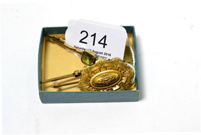 Lot 214 - A 15ct gold scroll decorated brooch and two stone set bar brooches stamped '9CT' (3)