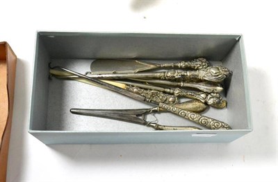 Lot 217 - A small collection of silver mounted button hooks, shoe horns, glove stretcher etc