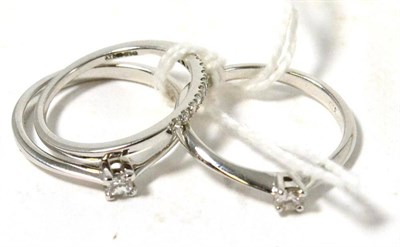 Lot 225 - Two 9ct white gold diamond solitaire rings and a 9ct white gold diamond half hoop ring