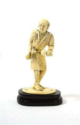 Lot 232 - A Japanese ivory okimono of a man, on an ebonised plinth, 15cm